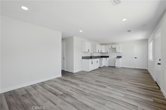 44242 Benald St, Lancaster, CA 93535 - unfurnished living room with a sink, light wood-style flooring, baseboards, and recessed lighting
