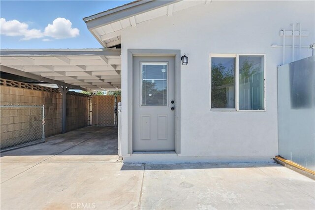44242 Benald St, Lancaster, CA 93535 - entrance to property with stucco siding and an attached carport