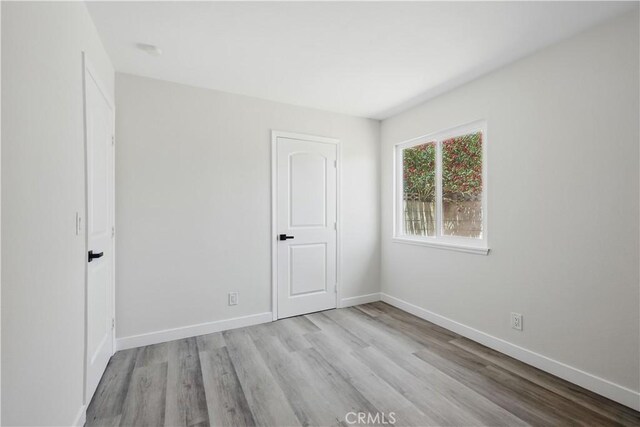 44242 Benald St, Lancaster, CA 93535 - unfurnished bedroom featuring wood finished floors and baseboards