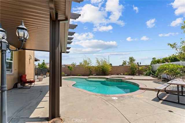 1600 Liv Ct, Redlands, CA 92374 - view of swimming pool featuring a fenced backyard, a patio area, and a pool with connected hot tub