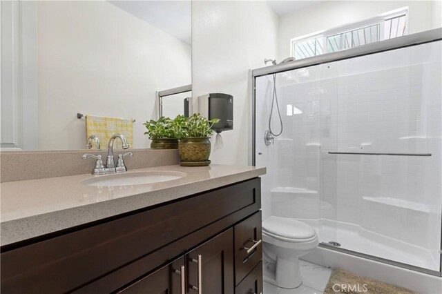 1600 Liv Ct, Redlands, CA 92374 - full bath with a shower stall, vanity, toilet, and marble look tiles