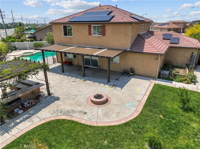 1600 Liv Ct, Redlands, CA 92374 - back of house with stucco siding, a patio, solar panels, and an outdoor fire pit