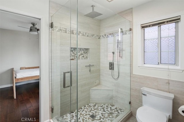 25009 Wintergreen Ct, Stevenson Ranch, CA 91381 - ensuite bathroom with a stall shower, toilet, wood finished floors, and ceiling fan