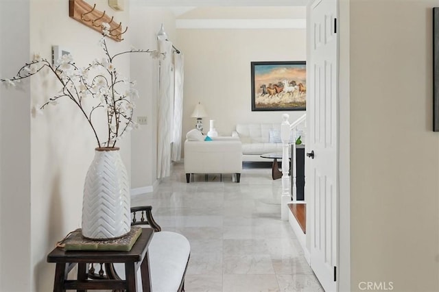 25009 Wintergreen Ct, Stevenson Ranch, CA 91381 - corridor featuring light marble finish floors and baseboards