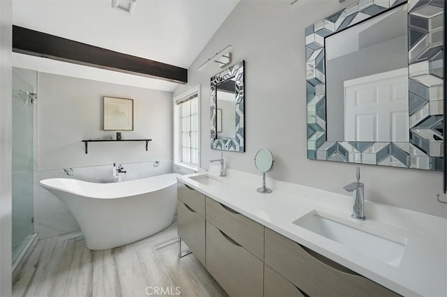 25009 Wintergreen Ct, Stevenson Ranch, CA 91381 - bathroom with a freestanding bath, double vanity, and beam ceiling