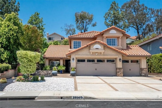 25009 Wintergreen Ct, Stevenson Ranch, CA 91381 - mediterranean / spanish house featuring stucco siding, a garage, driveway, and a tiled roof