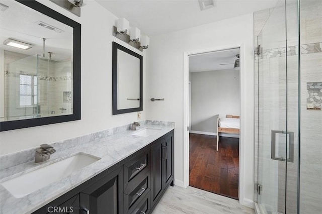 25009 Wintergreen Ct, Stevenson Ranch, CA 91381 - ensuite bathroom featuring a shower stall, double vanity, baseboards, and wood finished floors