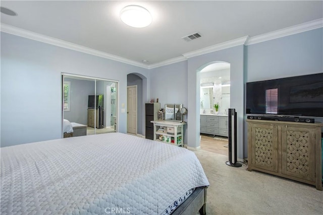 543 Garden Ave, Pomona, CA 91767 - bedroom with crown molding, arched walkways, light colored carpet, and ensuite bathroom