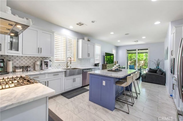 543 Garden Ave, Pomona, CA 91767 - kitchen featuring dishwasher, island range hood, a center island, tasteful backsplash, and a kitchen breakfast bar