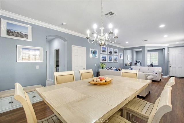 543 Garden Ave, Pomona, CA 91767 - dining area featuring crown molding, a chandelier, arched walkways, dark wood finished floors, and recessed lighting