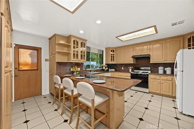 738 Hampton Rd, Arcadia, CA 91006 - kitchen with white appliances, under cabinet range hood, a breakfast bar area, a peninsula, and glass insert cabinets