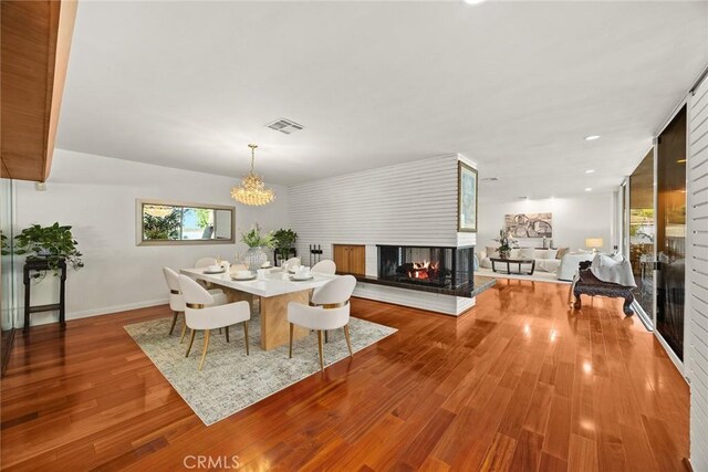 738 Hampton Rd, Arcadia, CA 91006 - dining space with a multi sided fireplace, a chandelier, and wood finished floors