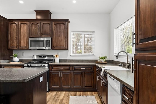 5972 Peck Ln, Paradise, CA 95969 - kitchen with appliances with stainless steel finishes, light wood-type flooring, dark countertops, recessed lighting, and dark brown cabinets