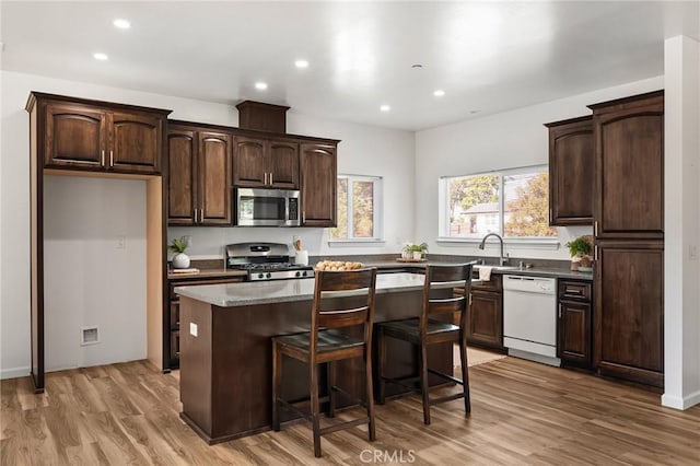 5972 Peck Ln, Paradise, CA 95969 - kitchen featuring stainless steel appliances, a kitchen island, dark brown cabinetry, light wood-style flooring, and recessed lighting