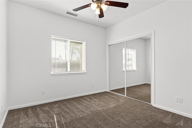 5972 Peck Ln, Paradise, CA 95969 - unfurnished bedroom featuring carpet flooring, multiple windows, a closet, and a ceiling fan
