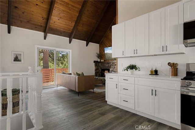 27947 St Bernard Ln, Lake Arrowhead, CA 92352 - kitchen with appliances with stainless steel finishes, wood ceiling with exposed beams, dark wood finished floors, white cabinetry, and high vaulted ceiling