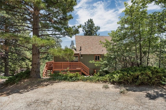 27947 St Bernard Ln, Lake Arrowhead, CA 92352 - view of property exterior featuring stairs, a deck, and a shingled roof