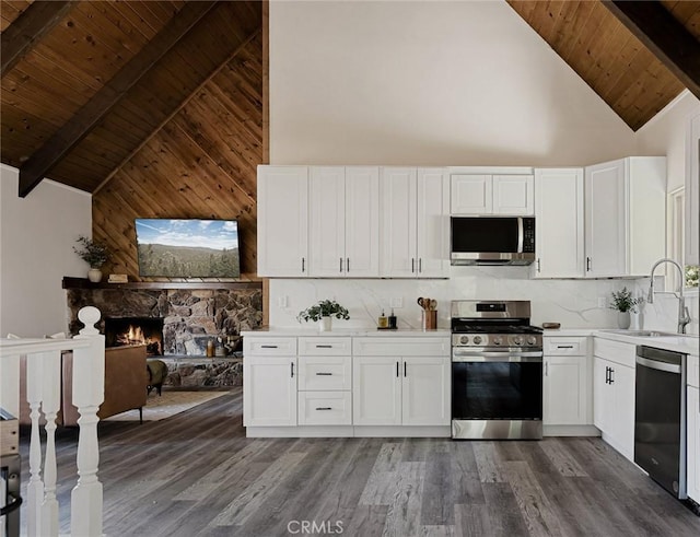 27947 St Bernard Ln, Lake Arrowhead, CA 92352 - kitchen with stainless steel appliances, a sink, high vaulted ceiling, wooden ceiling with exposed beams, and dark wood-style floors