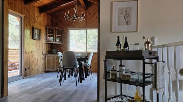 27947 St Bernard Ln, Lake Arrowhead, CA 92352 - dining space featuring wooden walls, light wood finished floors, wooden ceiling, and a chandelier