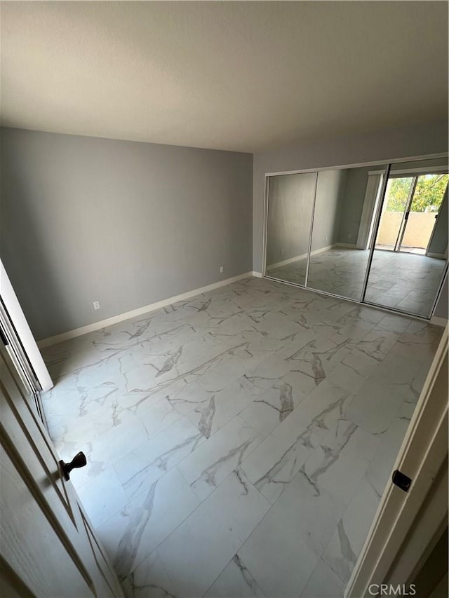 21212 Camelia Unit 46, Lake Forest, CA 92630 - unfurnished bedroom with marble finish flooring, baseboards, and a closet