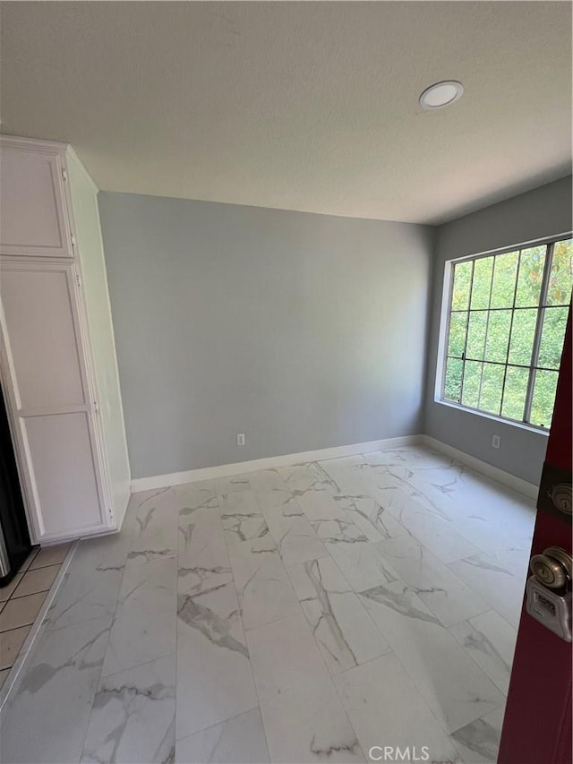 21212 Camelia Unit 46, Lake Forest, CA 92630 - spare room with baseboards, light marble finish floors, recessed lighting, and a textured ceiling