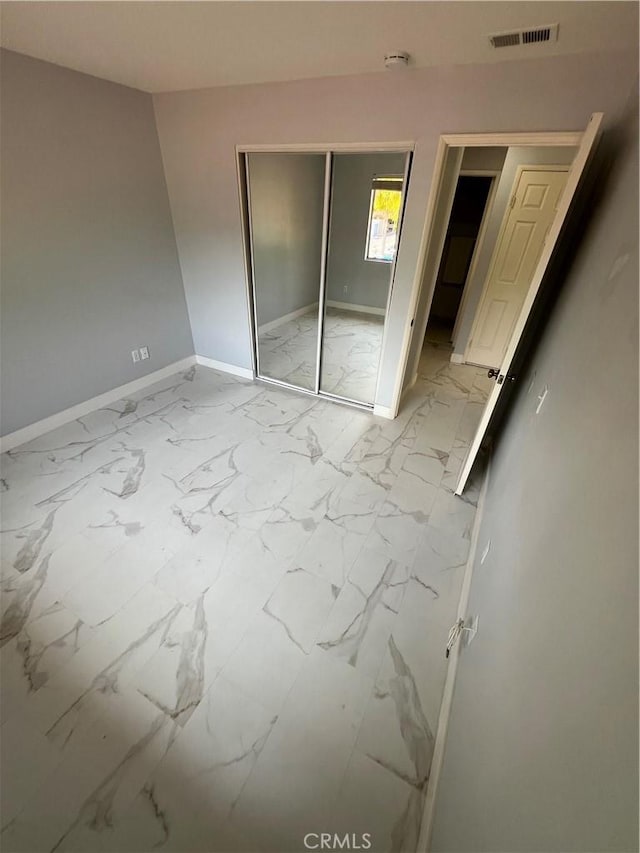 21212 Camelia Unit 46, Lake Forest, CA 92630 - unfurnished bedroom with marble finish floors, baseboards, and a closet