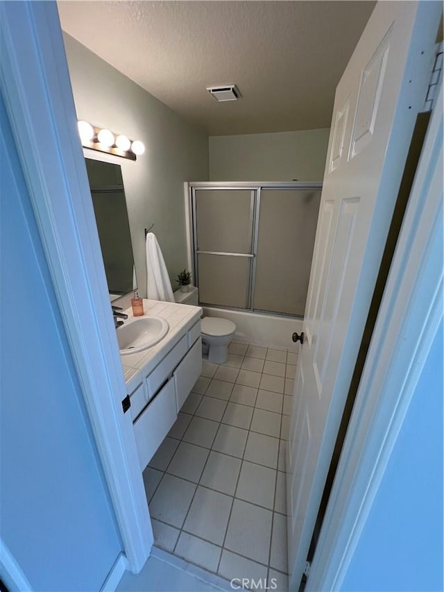 21212 Camelia Unit 46, Lake Forest, CA 92630 - full bathroom with tile patterned floors, vanity, toilet, shower / bath combination with glass door, and a textured ceiling