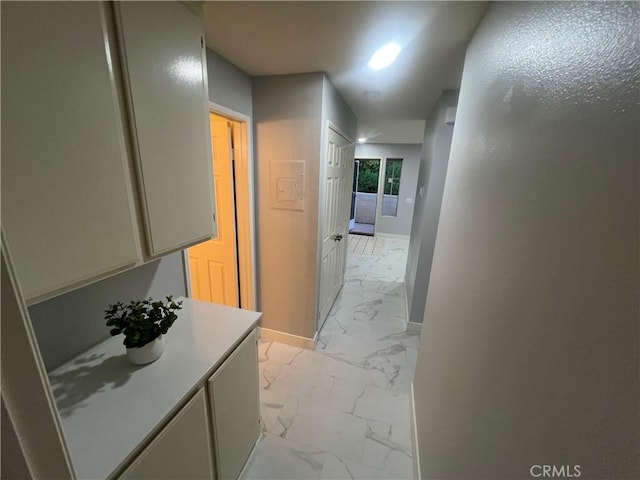 21212 Camelia Unit 46, Lake Forest, CA 92630 - hallway with light marble finish flooring and baseboards