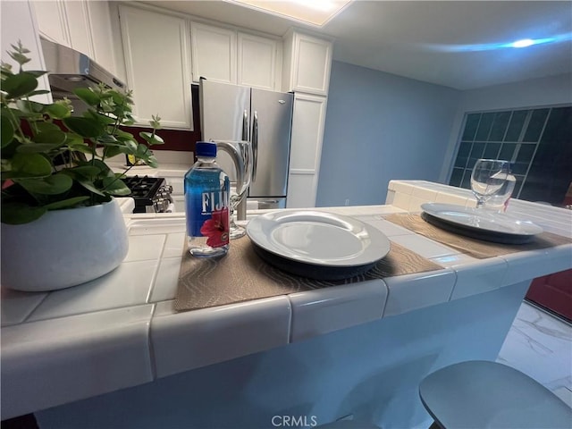 21212 Camelia Unit 46, Lake Forest, CA 92630 - kitchen featuring freestanding refrigerator, tile counters, and white cabinets