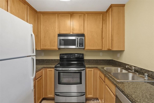2400 San Gabriel Way Unit 205, Corona, CA 92882 - kitchen featuring appliances with stainless steel finishes, a sink, and dark countertops