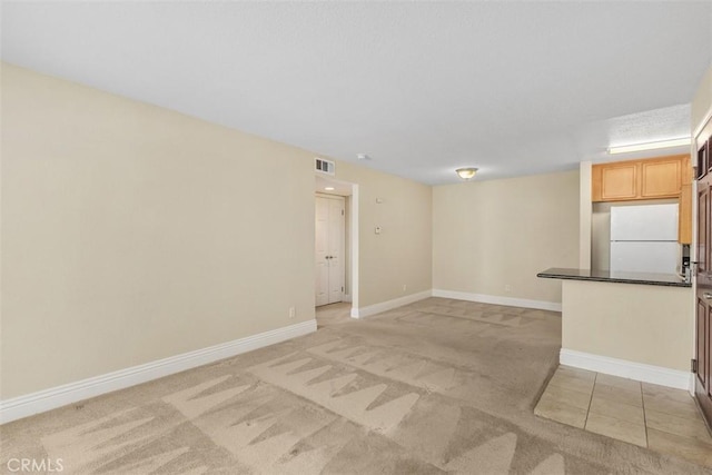 2400 San Gabriel Way Unit 205, Corona, CA 92882 - unfurnished living room with light colored carpet and baseboards