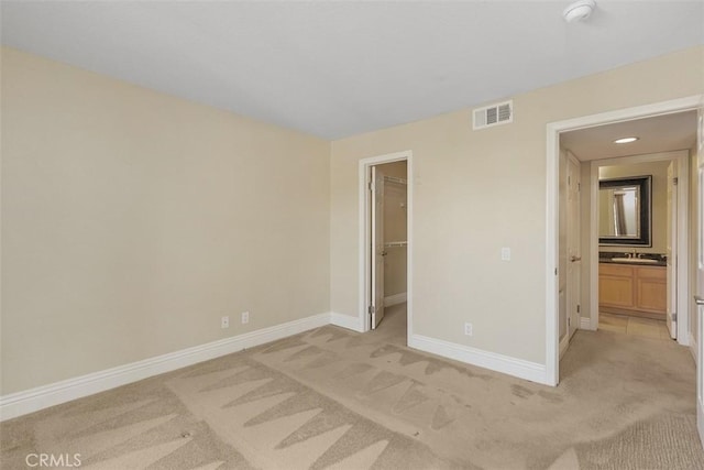 2400 San Gabriel Way Unit 205, Corona, CA 92882 - unfurnished bedroom featuring light colored carpet, baseboards, a spacious closet, a sink, and a closet