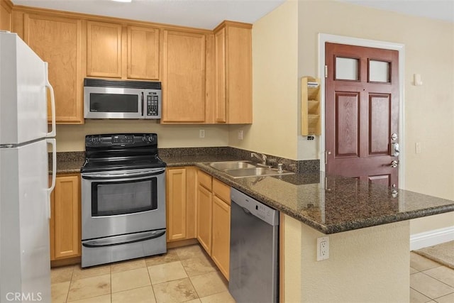 2400 San Gabriel Way Unit 205, Corona, CA 92882 - kitchen with stainless steel appliances, a sink, a peninsula, light tile patterned floors, and dark stone counters
