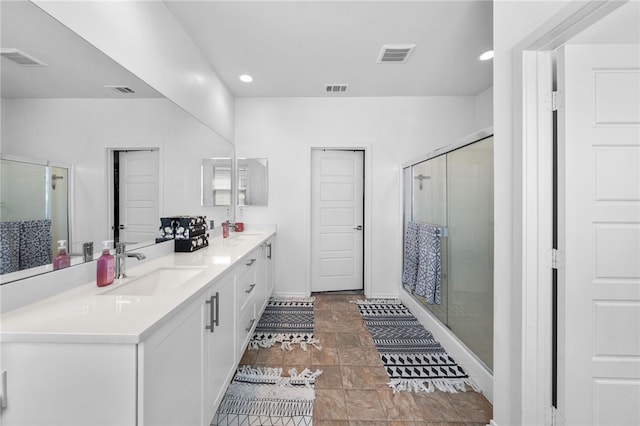 1372 Bello Pl, San Jacinto, CA 92582 - bathroom with double vanity, a shower stall, recessed lighting, baseboards, and stone finish flooring