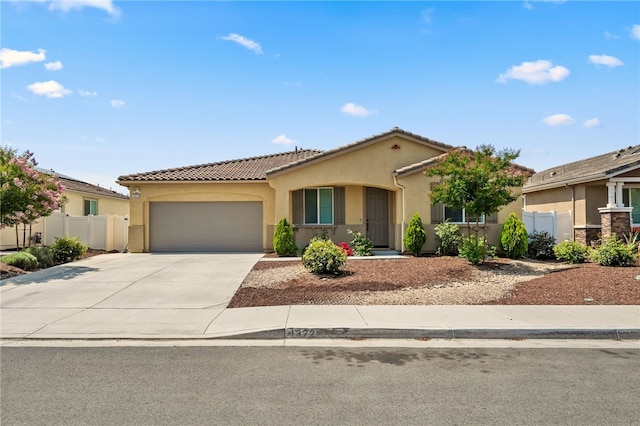 1372 Bello Pl, San Jacinto, CA 92582 - view of front facade with stucco siding, a tiled roof, a garage, and concrete driveway