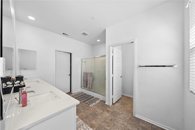 1372 Bello Pl, San Jacinto, CA 92582 - bathroom featuring a shower stall, double vanity, recessed lighting, stone finish flooring, and baseboards