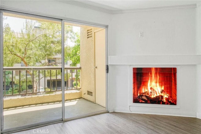 5500 Owensmouth Ave Unit 218, Woodland Hills, CA 91367 - doorway to outside with wood finished floors, a lit fireplace, ornamental molding, and baseboards