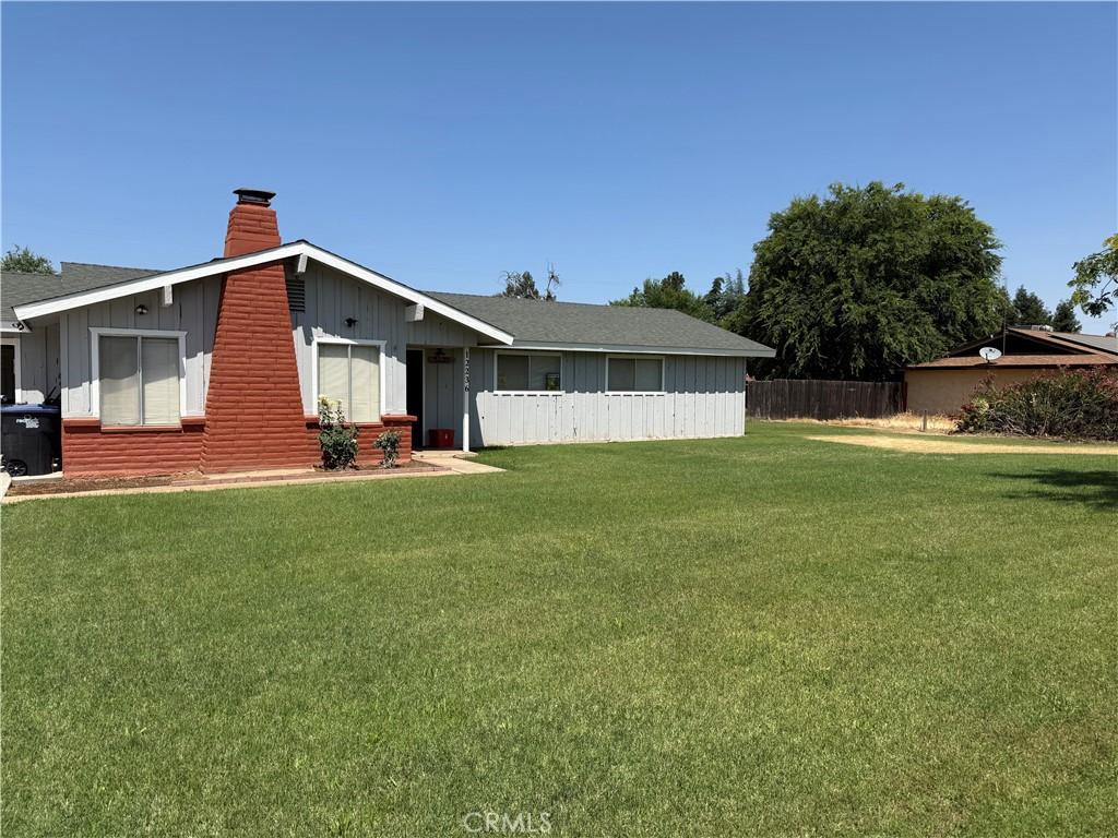 12236 Gabor Way, Madera, CA 93636 - view of front facade with a chimney, board and batten siding, and a shingled roof