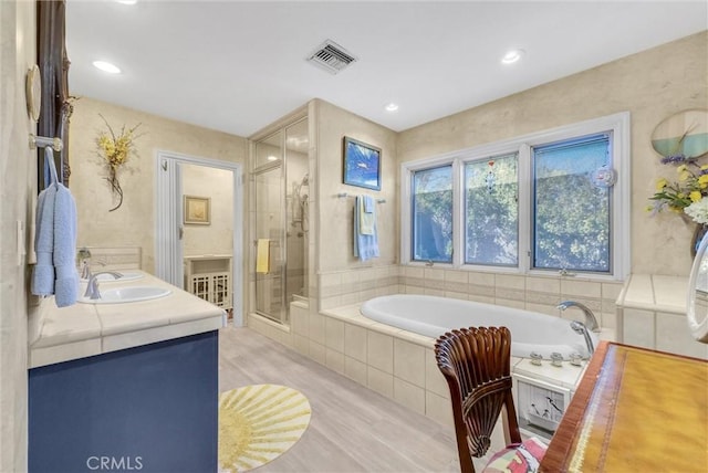 6309 Via Colinita, Rancho Palos Verdes, CA 90275 - bathroom featuring wood finished floors, a bath, a shower stall, double vanity, and recessed lighting