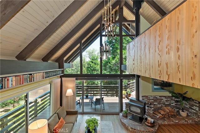 27280 Peninsula Dr, Lake Arrowhead, CA 92352 - living area with a wood stove, wood finished floors, wood ceiling with exposed beams, high vaulted ceiling, and a chandelier