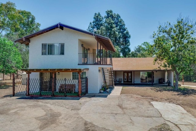 17620 Lyons Valley Rd, Jamul, CA 91935 - view of front facade with stairs, stucco siding, and a balcony