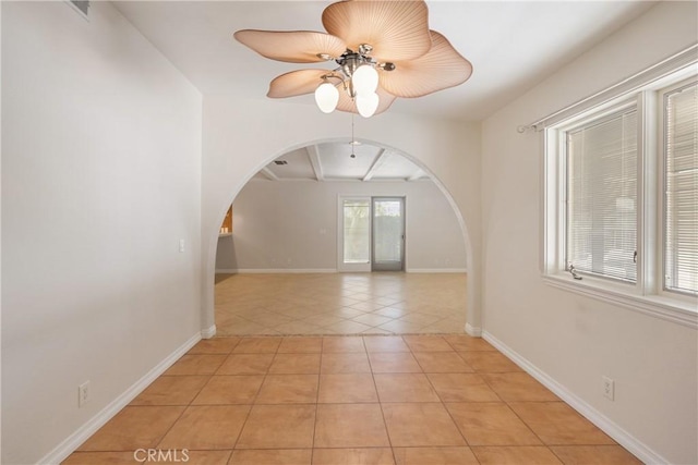 45740 Verba Santa Dr, Palm Desert, CA 92260 - unfurnished room with arched walkways, light tile patterned flooring, ceiling fan, and beamed ceiling