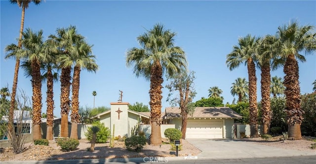 45740 Verba Santa Dr, Palm Desert, CA 92260 - view of front facade with an attached garage, driveway, and stucco siding
