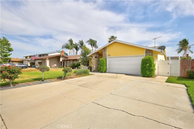 4163 Alma Ct, Chino, CA 91710 - mid-century home featuring a gate, stone siding, a garage, and driveway