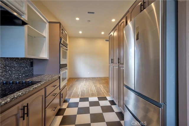 4163 Alma Ct, Chino, CA 91710 - kitchen with freestanding refrigerator, black electric stovetop, dark flooring, wall chimney range hood, and recessed lighting