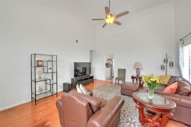 22784 Wren St, Grand Terrace, CA 92313 - living area with high vaulted ceiling, ceiling fan, light wood finished floors, and baseboards