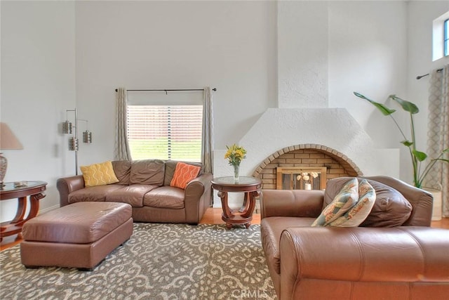 22784 Wren St, Grand Terrace, CA 92313 - living area featuring a towering ceiling, wood finished floors, and a brick fireplace