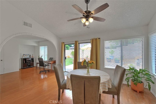 22784 Wren St, Grand Terrace, CA 92313 - dining space with a textured ceiling, light wood finished floors, arched walkways, lofted ceiling, and a ceiling fan