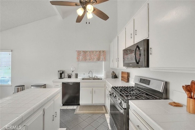 22784 Wren St, Grand Terrace, CA 92313 - kitchen featuring black appliances, tile countertops, ceiling fan, white cabinets, and lofted ceiling