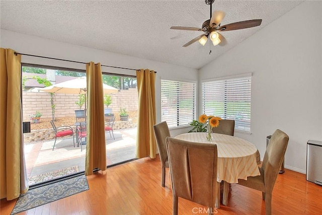 22784 Wren St, Grand Terrace, CA 92313 - dining area with a textured ceiling, vaulted ceiling, light wood-style flooring, and a ceiling fan